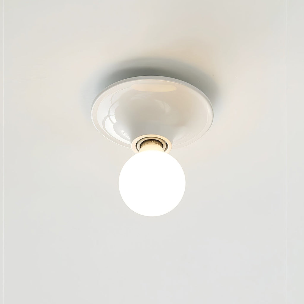 Eclipta wall sconce with mirrored bulb reflecting the room