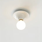 Eclipta wall sconce with mirrored bulb reflecting the room