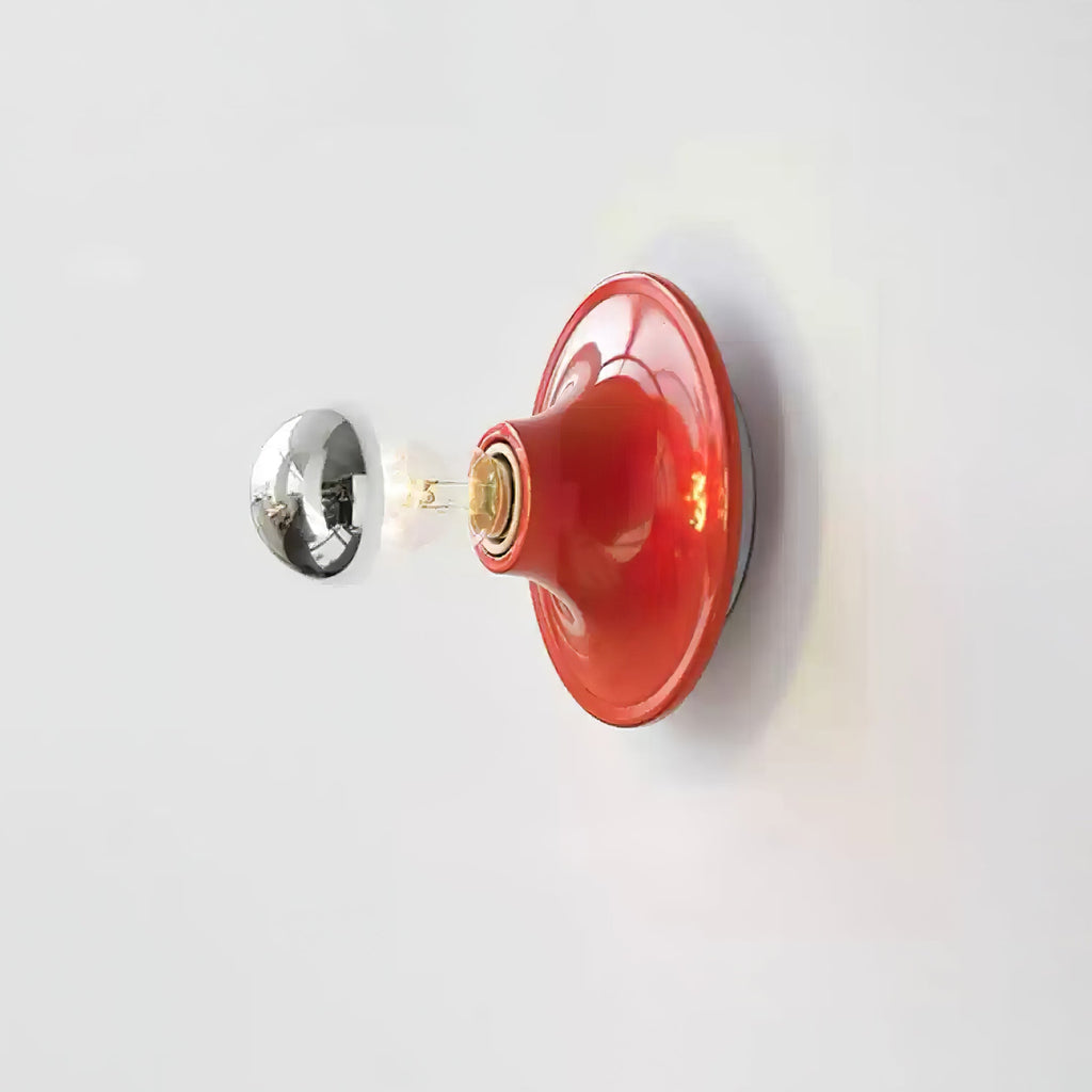 Eclipta wall sconce casting a gentle halo of light