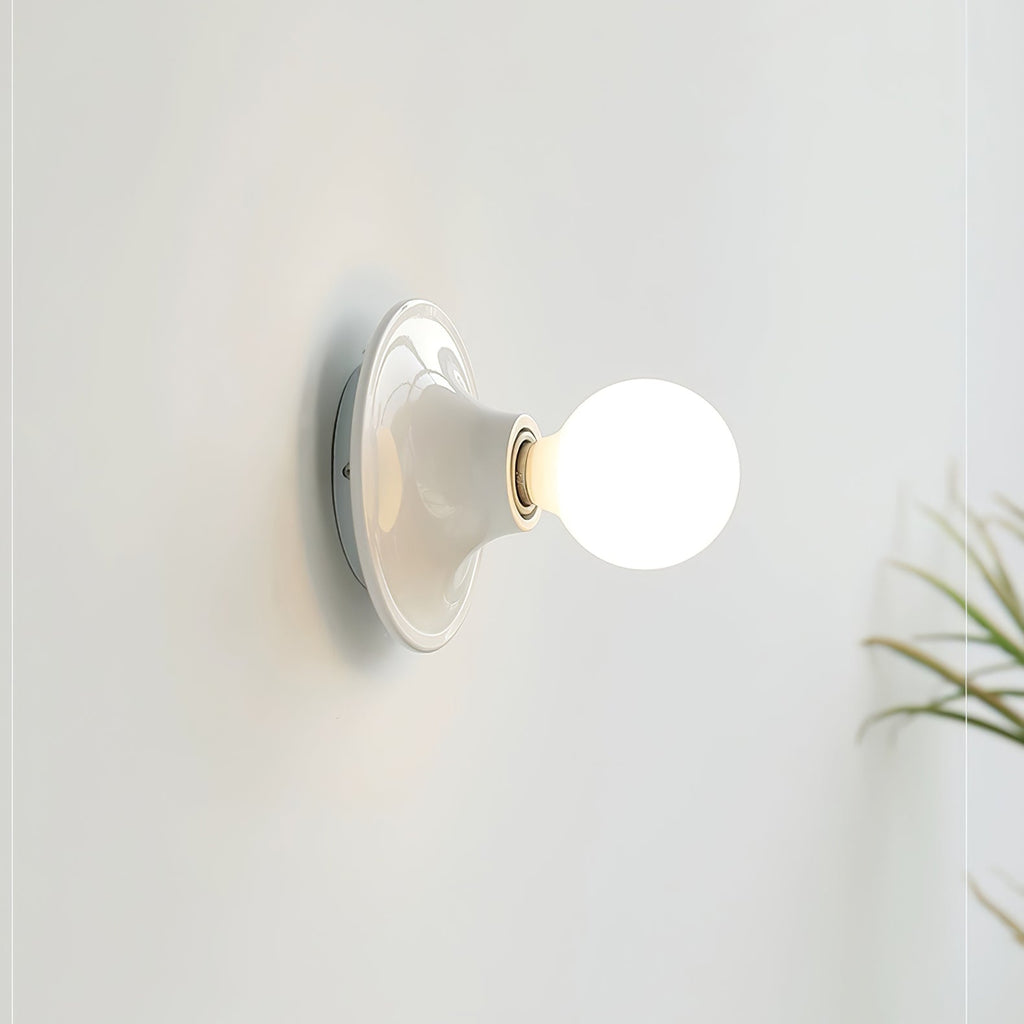 Eclipta wall sconce shown in profile against a plain wall