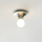 Eclipta wall sconce in a nickel finish on a light wall