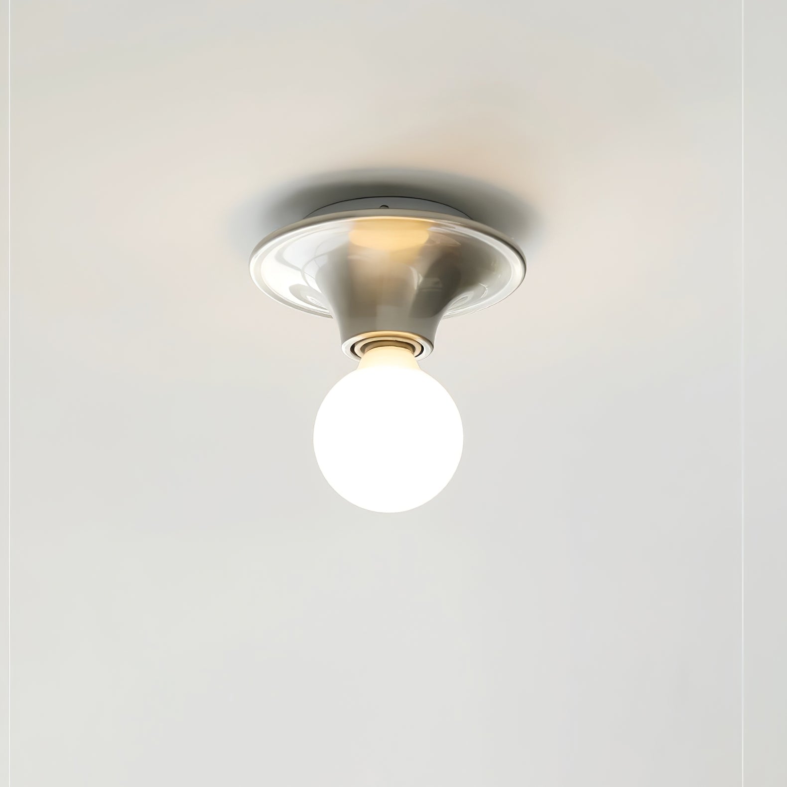 Eclipta wall sconce in a nickel finish on a light wall