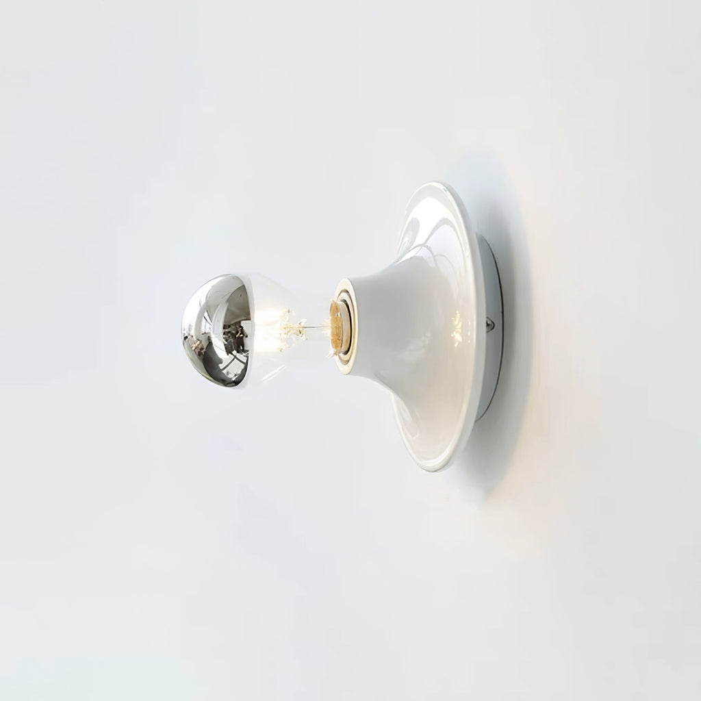 Eclipta wall sconce with its mirrored bulb seen up close