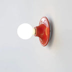 Close view of the curved metal base of the Eclipta wall sconce
