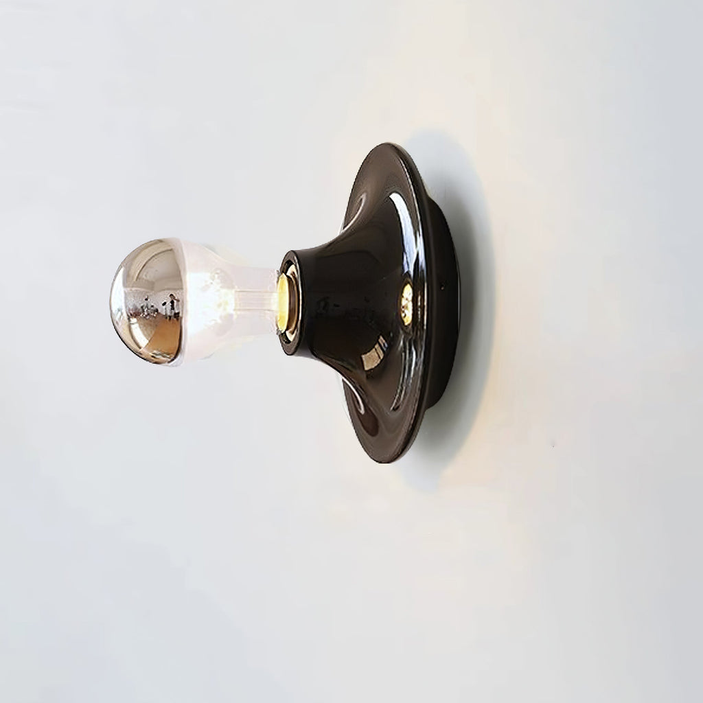 Eclipta wall sconce lighting a quiet corner of a studio