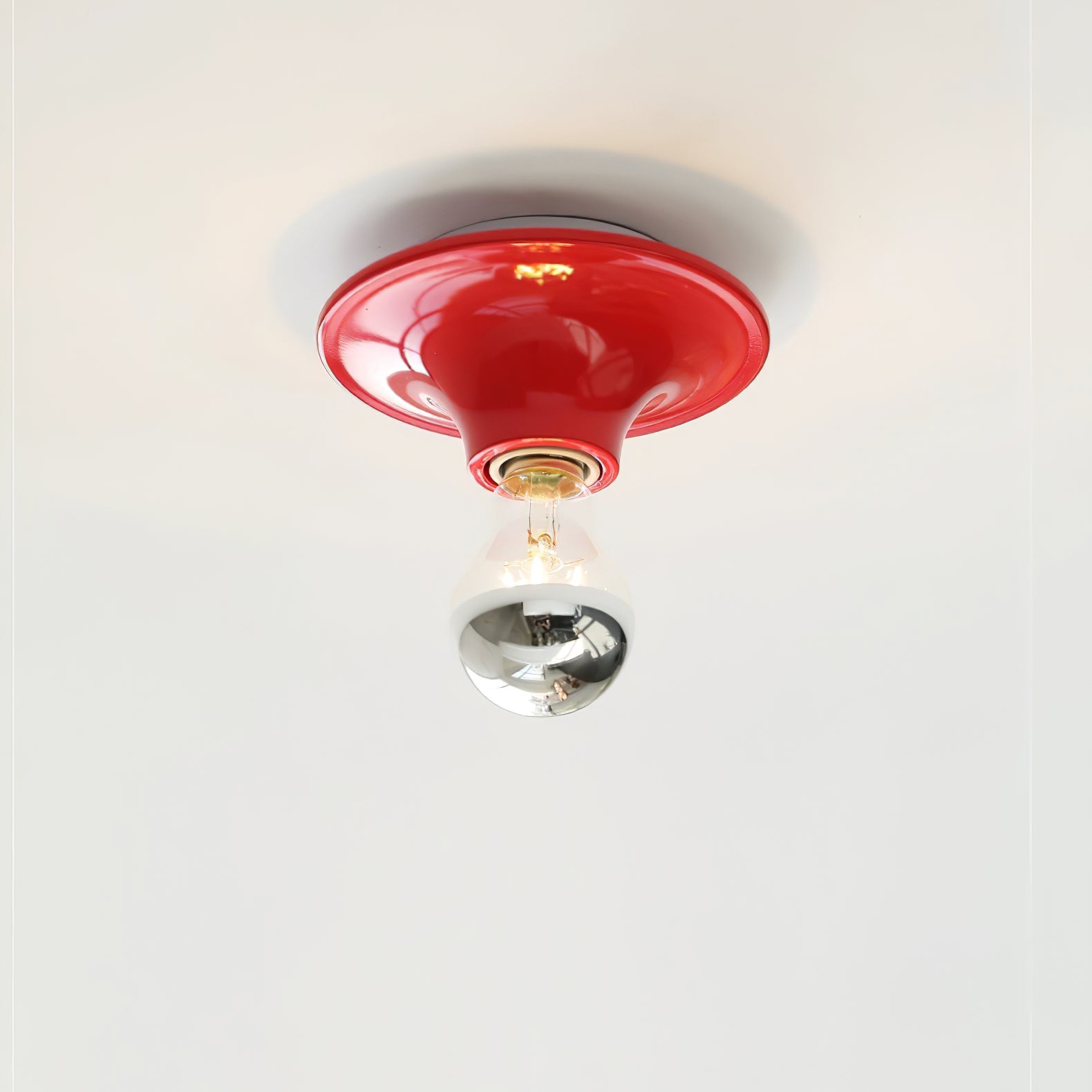 Eclipta wall sconce glowing softly in a modern cafe setting