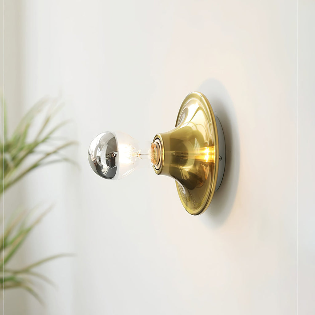 Eclipta wall sconce shown close up with its trumpet-shaped base