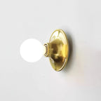 Mirrored glass bulb of the Eclipta sconce reflecting its own light