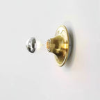 Eclipta wall sconce glowing in a softly lit room at dusk