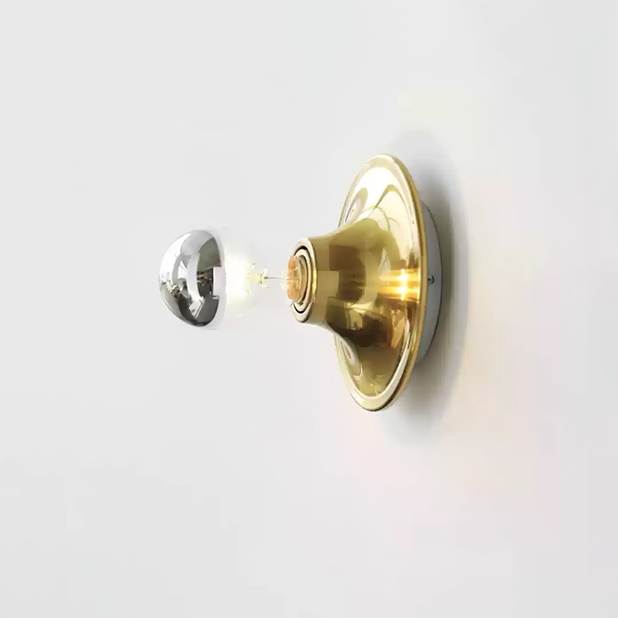 Eclipta wall sconce glowing in a softly lit room at dusk