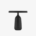 Close silhouette of the black Clérachic table lamp against a plain white background, showing the bottle-shaped base and shade.
