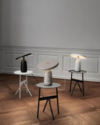 The same three Clérachic table lamps from further back, showing the full herringbone parquet floor beneath them.