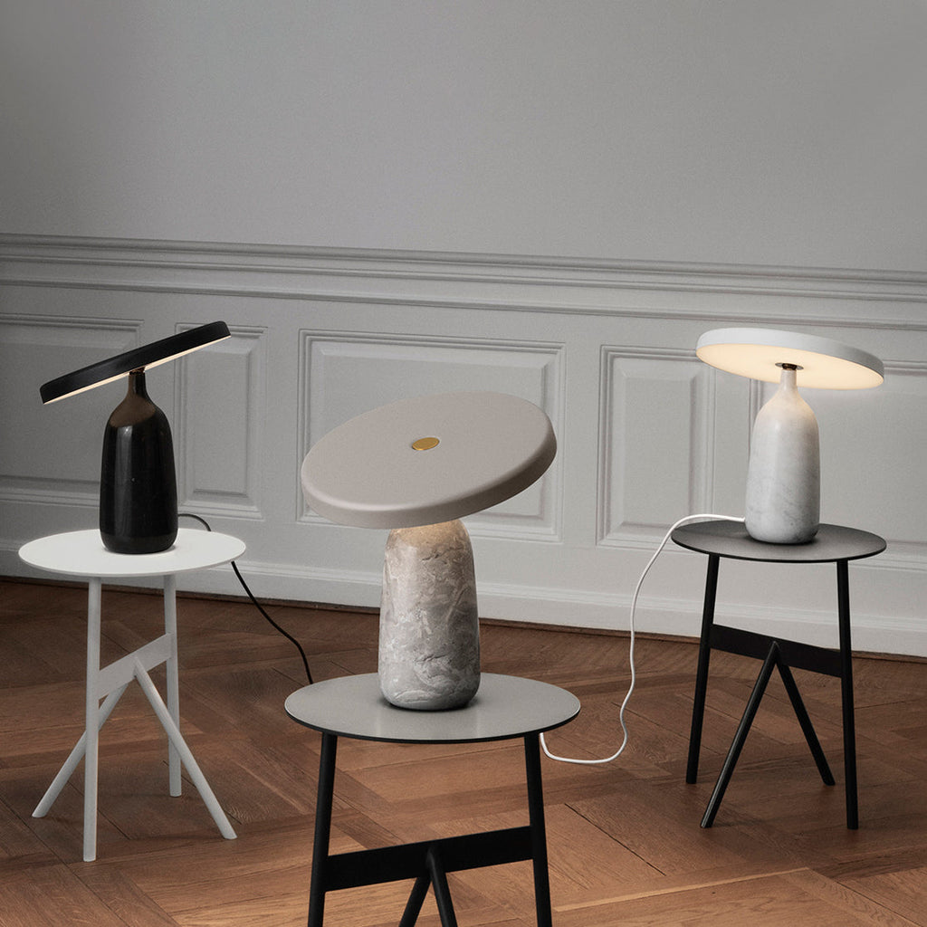 Three Clérachic table lamps in black, grey marble and white, photographed from a slightly wider angle in the room.