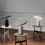 Three Clérachic table lamps in black, grey marble and white, photographed from a slightly wider angle in the room.