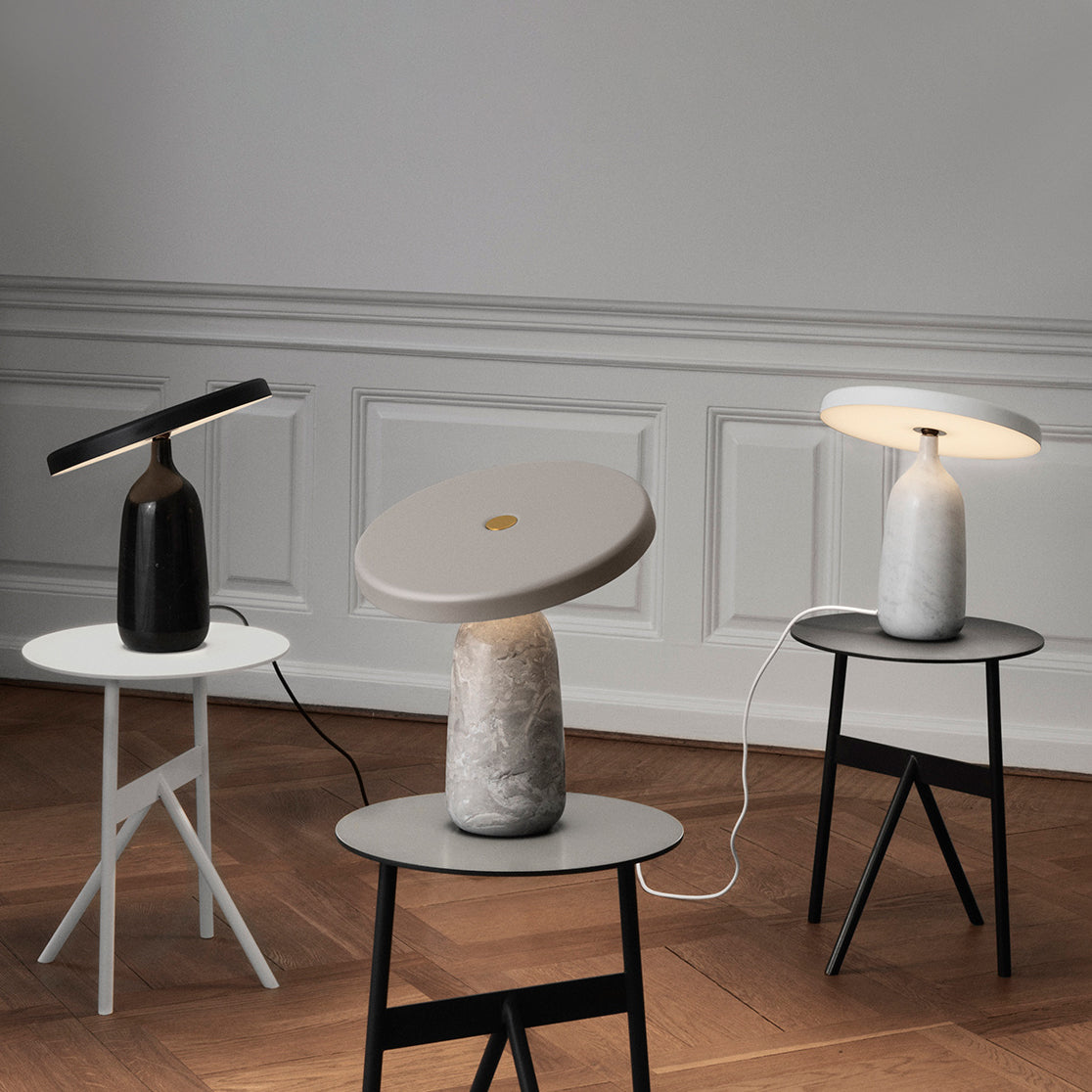 Three Clérachic table lamps in black, grey marble and white, photographed from a slightly wider angle in the room.