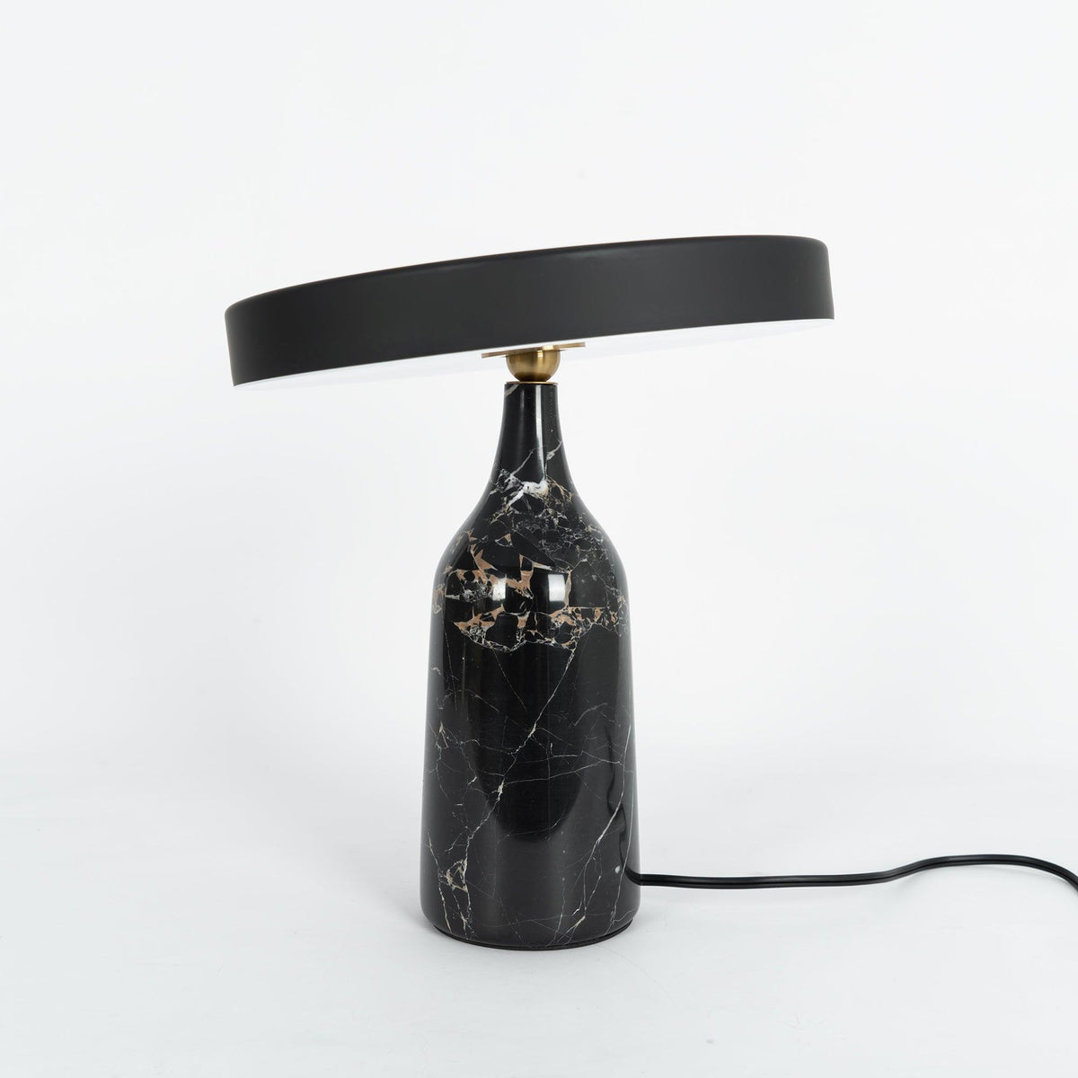 Black marble Clérachic table lamp with visible gold veining, disc shade held level, shown on a plain white background.