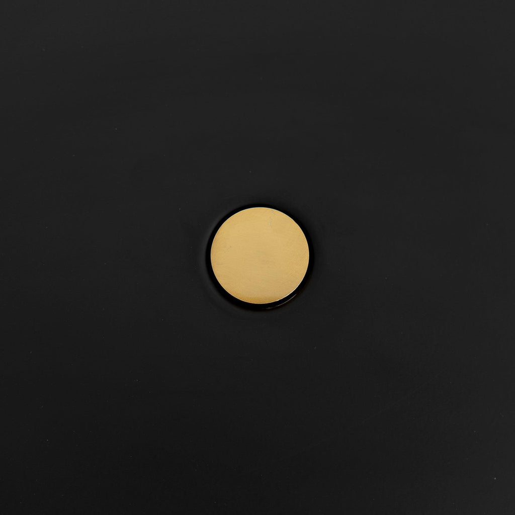 Macro close-up of the brass pivot knob at the centre of the Clérachic table lamp's black disc shade.