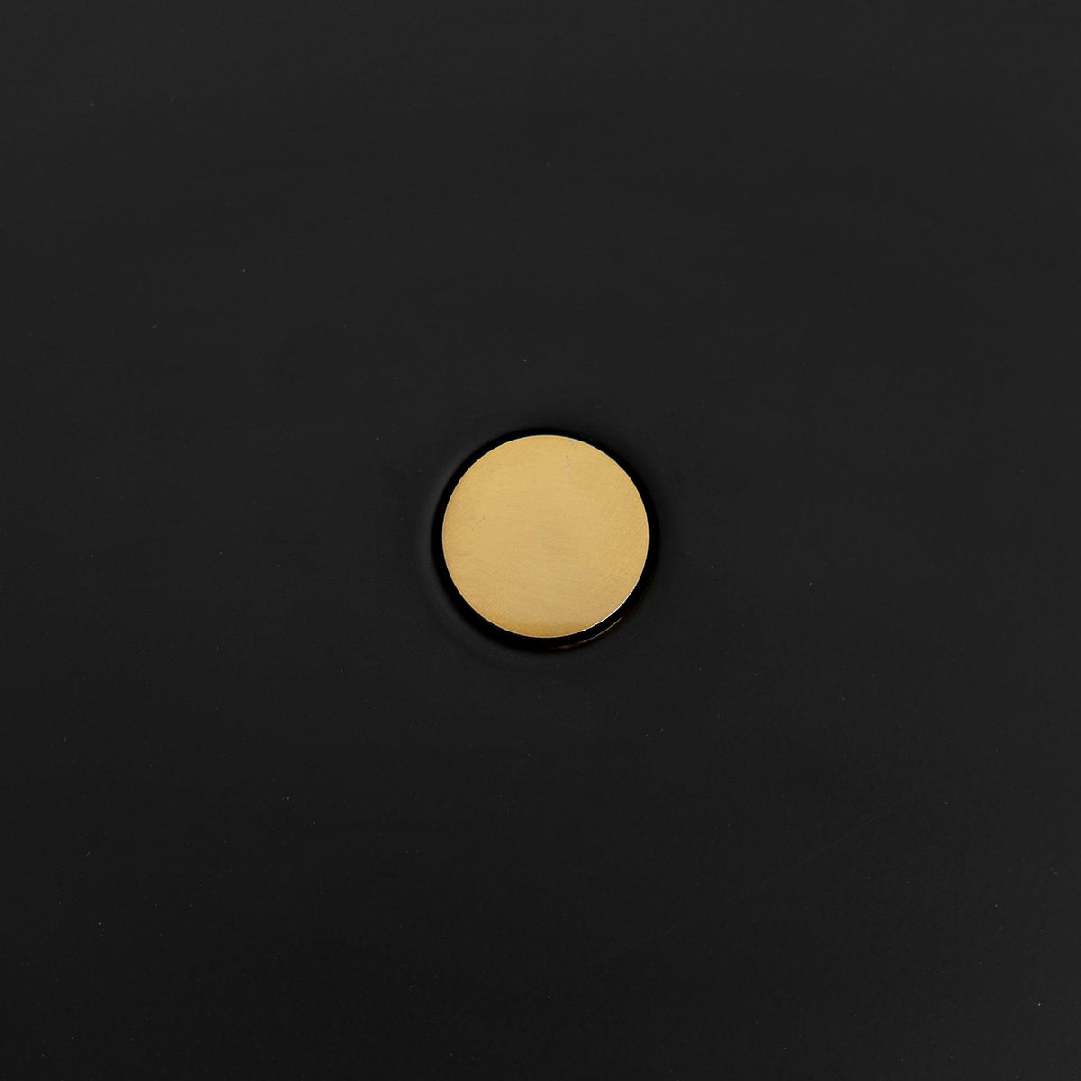 Macro close-up of the brass pivot knob at the centre of the Clérachic table lamp's black disc shade.