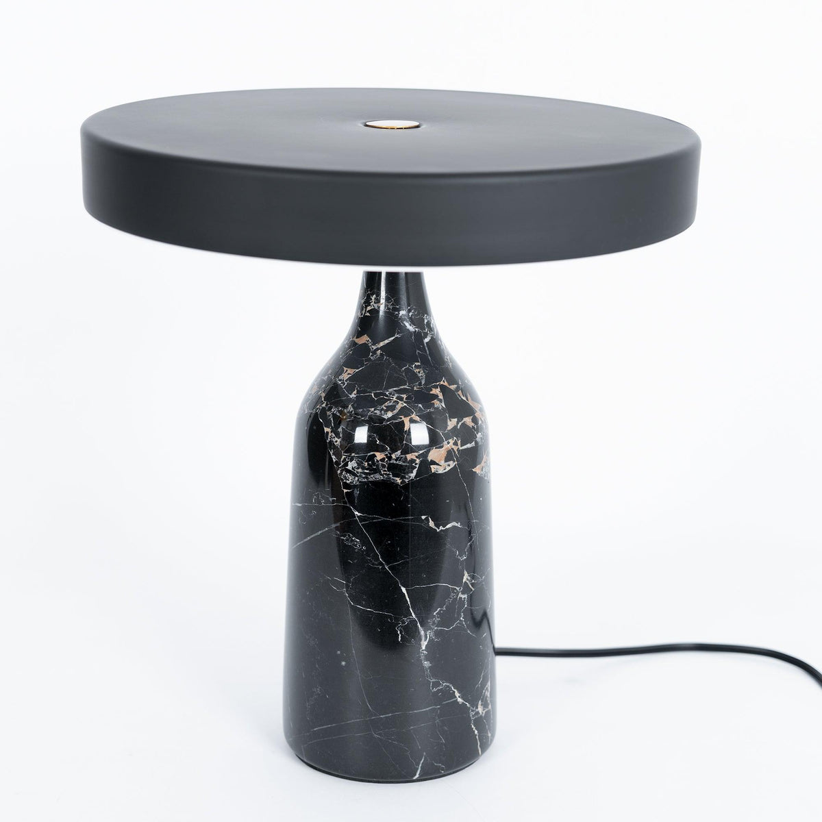 Black marble Clérachic table lamp, disc shade held level, a slightly wider studio crop with its cord visible.
