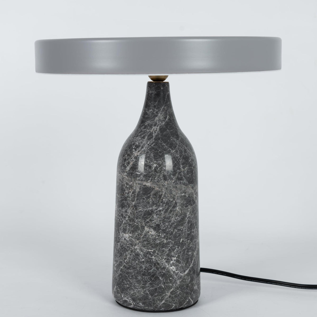 Grey marble Clérachic table lamp with a matching grey disc shade held level, shown with its cord on white.
