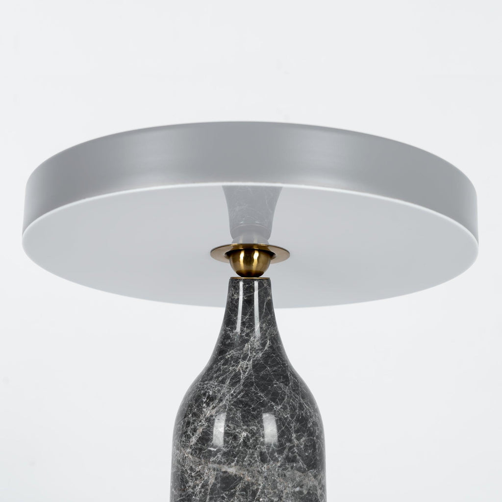 Close crop of the grey marble Clérachic table lamp's shade and neck, disc held level on a white background.