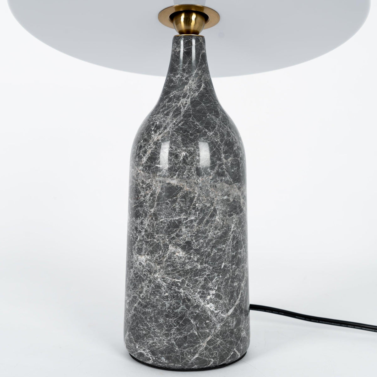 Close-up of the grey marble base on the Clérachic table lamp, showing its pale veined stone texture.