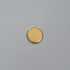 Macro close-up of the brass pivot knob at the centre of the Clérachic table lamp's grey disc shade.