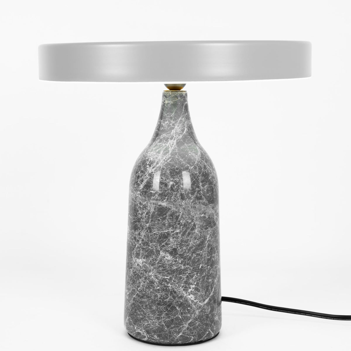Grey marble Clérachic table lamp with its disc shade held level, shown with its cord on a plain white background.