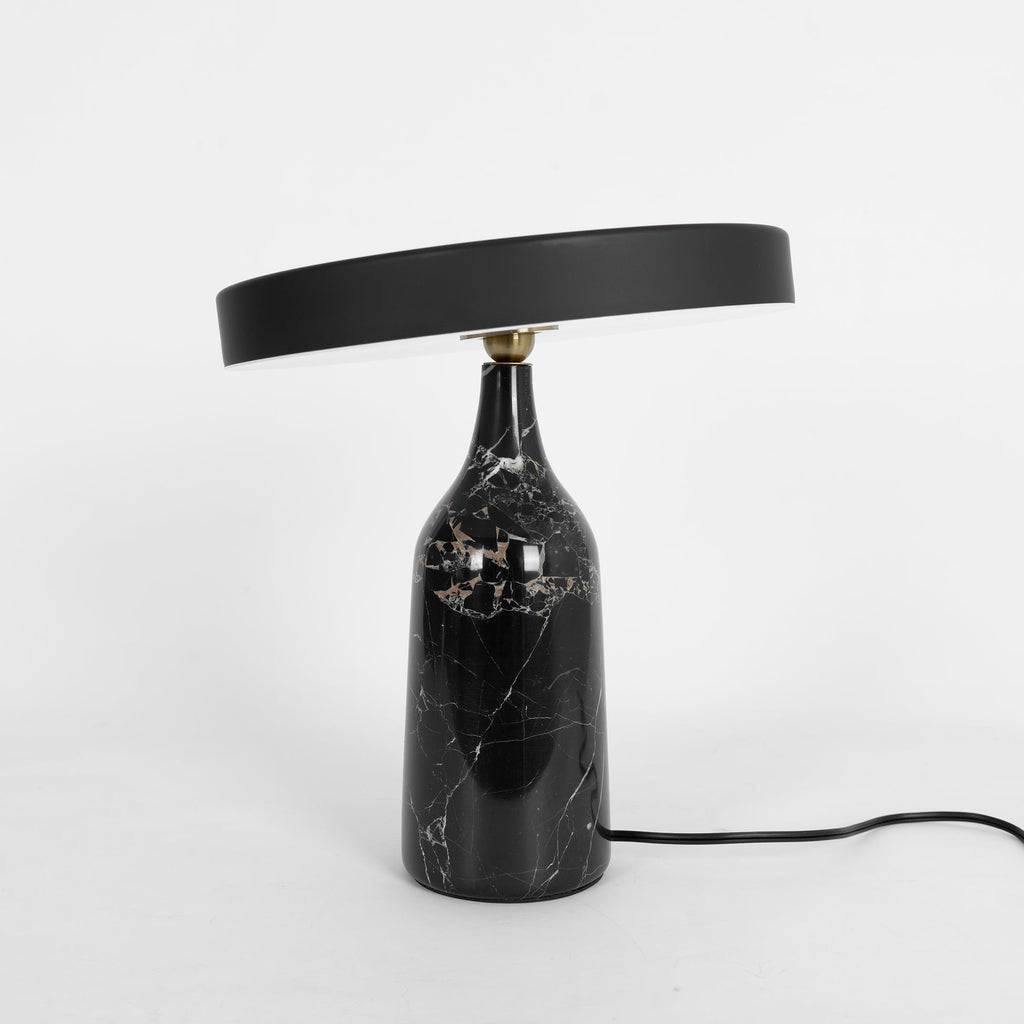 Black marble Clérachic table lamp, disc shade held level, a tall studio crop with the cord visible below.