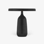 Black Clérachic table lamp shown in side profile against a plain background, the flat disc shade extended level from its base.