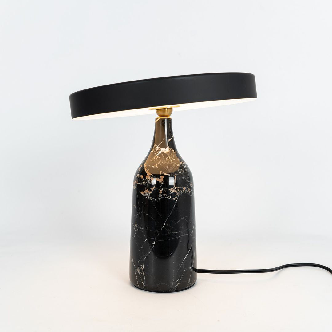 Black marble Clérachic table lamp with its disc shade held level, a clean studio shot with its cord visible.