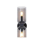 Both bulbs glow through the smoke grey glass of this matt black Clérachic sconce on white.