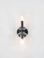 A close crop shows the lit bulb inside this matt black Clérachic wall light's smoke grey shade.