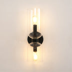Front and centred, this matt black Clérachic sconce shows both bulbs lit through clear glass.