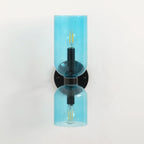 Each blue glass shade on this matt black Clérachic sconce glows around its own bulb.