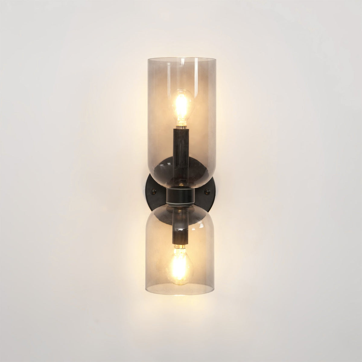 A tighter crop shows the smoke grey shades glowing on this matt black Clérachic wall light.