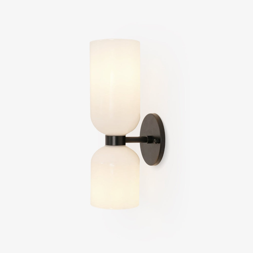 Centred on white, this matt black Clérachic sconce's opal glass shades sit unlit.