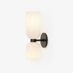 Centred on white, this matt black Clérachic sconce's opal glass shades sit unlit.