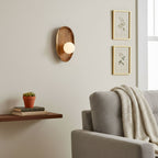 Walnut wood wall lamp mounted beside a doorway
