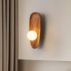 Walnut wood wall lamp in a styled room with warm light