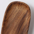 Walnut wood wall lamp mounted on a wall in soft light