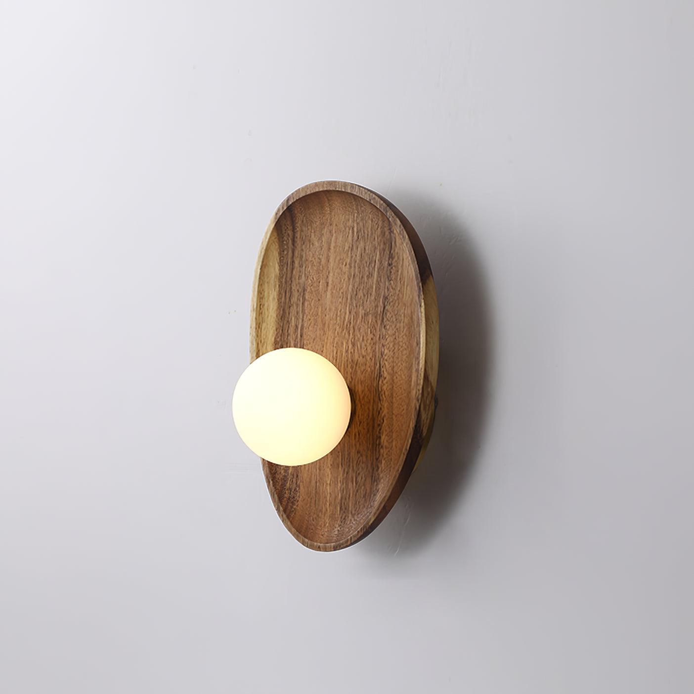 Walnut wood wall lamp casting a soft ambient glow on an accent wall