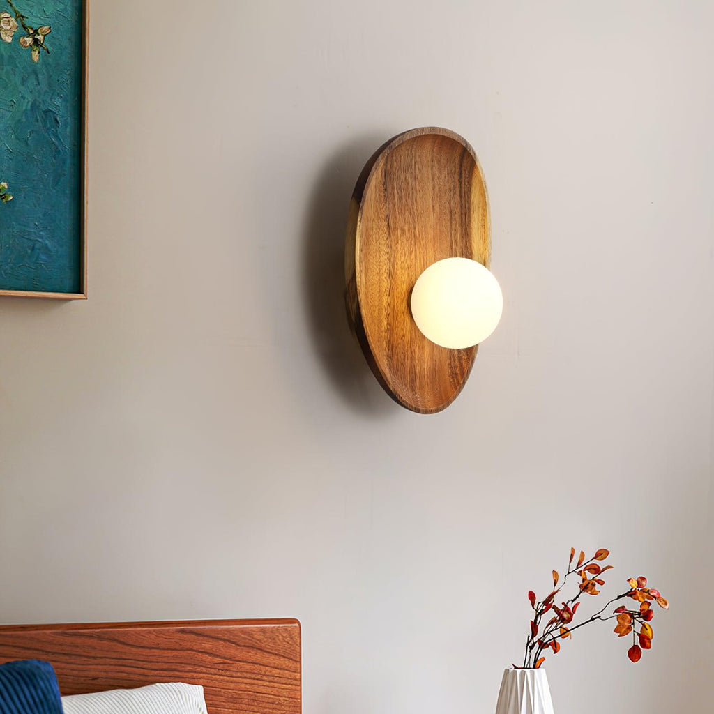 Walnut wood wall lamp detail of white glass shade lit