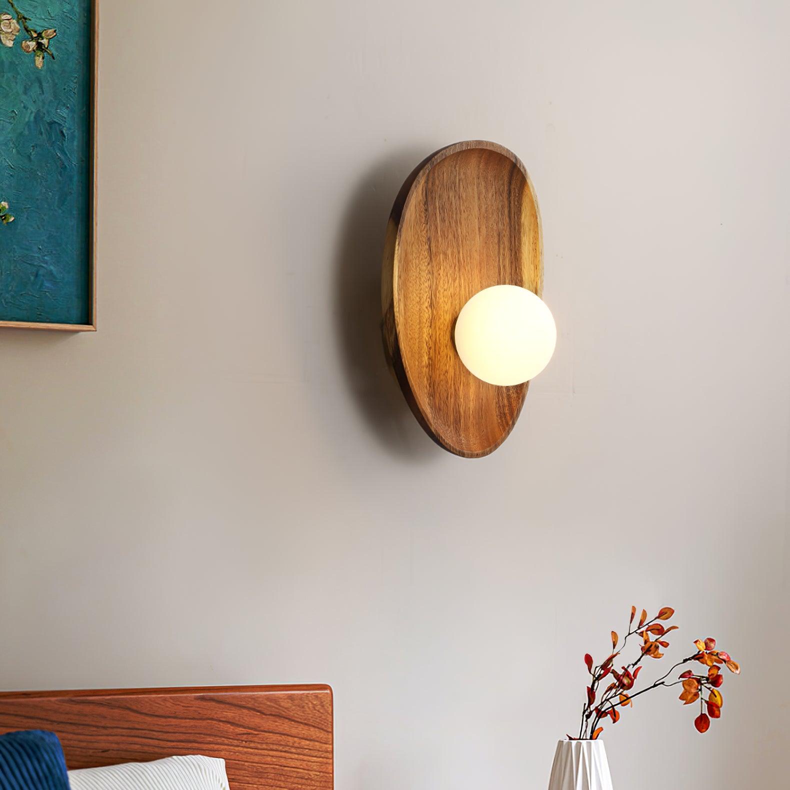 Walnut wood wall lamp detail of white glass shade lit