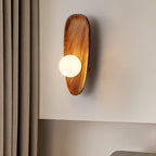 Walnut wood wall lamp detail showing the natural grain pattern