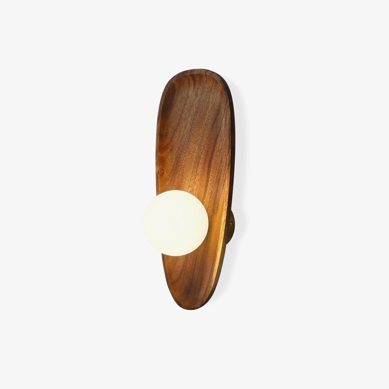 Walnut wood wall lamp mounted on a wall with white glass shade glowing