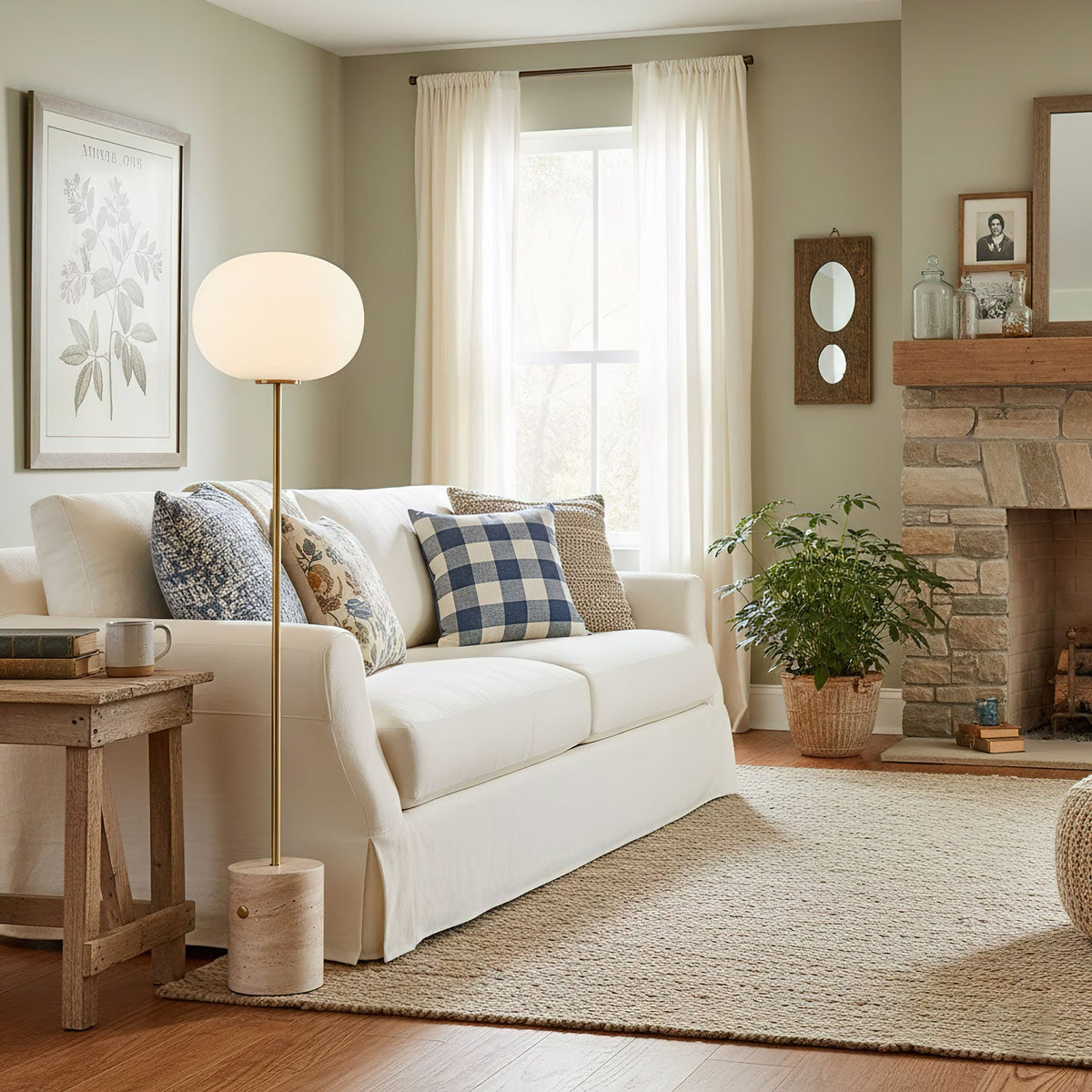The Clérachic floor lamp stands beside a white slipcovered sofa with plaid pillows and a potted fern, in a sage-toned room.