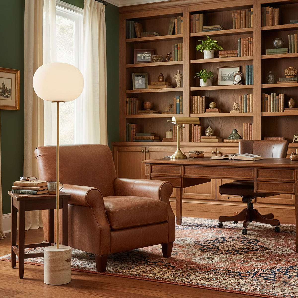 In a wood-panelled home office, the Clérachic floor lamp stands beside a brown leather armchair and built-in bookshelves.