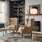A navy-walled reading nook shows the Clérachic floor lamp between two tufted wingback chairs and built-in bookshelves.