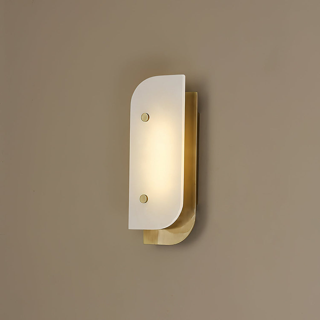 Short Elaris Alabaster Wall Light mounted on a warm taupe wall, brass backplate catching the lamp's own glow.